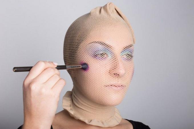 Carey comenzó a aplicar la sombra de ojos pincel de maquillaje directamente en la parte superior de una media-net.